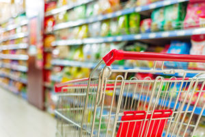 Grocery cart in store aisle